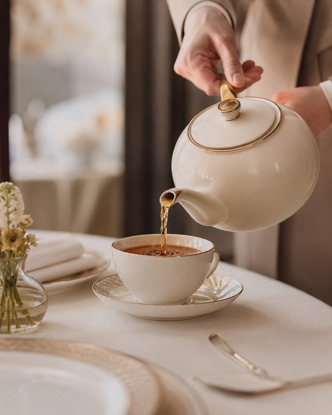 Tea poured into a gold-rimmed porcelain cup
